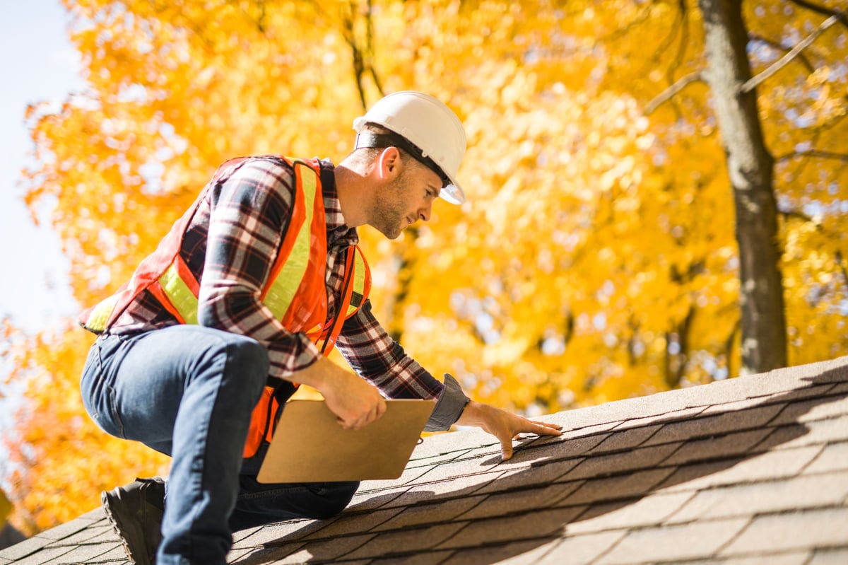 Roofing professional inspecting residential property in South Florida