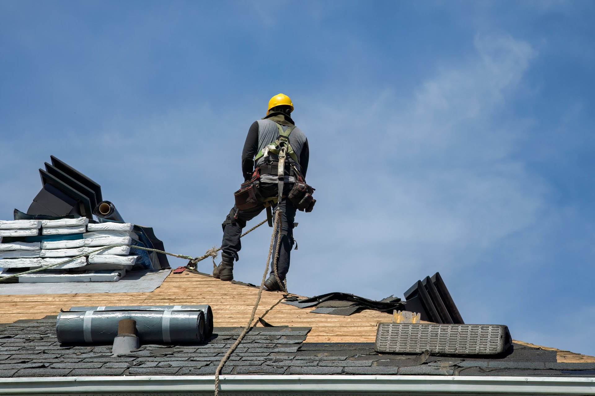 Professional roofer working on residential roof in South Florida
